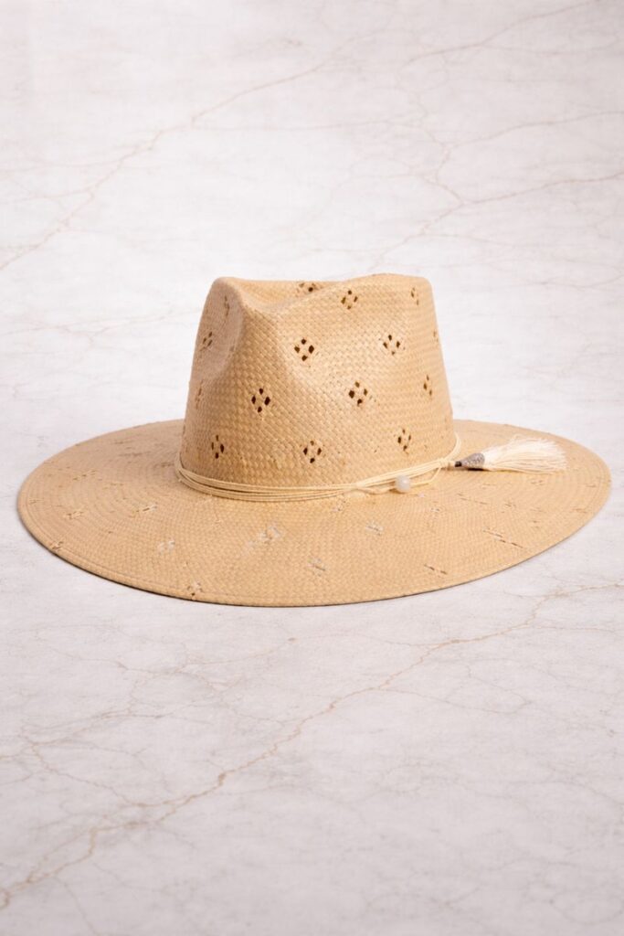 Angled studio photo of Lena safari straw sun hat with cord and tassel detail