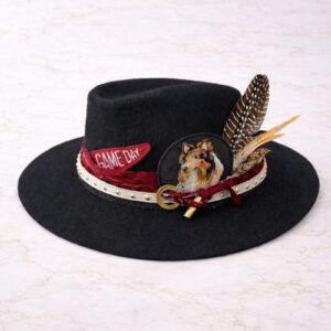 Game Day maroon and white wide brim Australian 100% wool felt hat by American Hat Makers, styled by Swanky Doodle in Fort Worth TX with collie patch, horseshoe pin, maroon chiffon ribbon, studded white leatherette band, and brown-white feathers