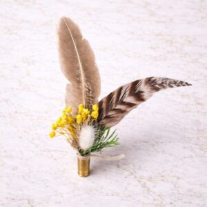 Yellow feather and dried flower hat accent in a brass casing, available at Swanky Doodle Boutique & Hat Bar near Fort Worth, TX.